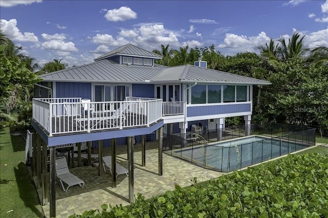 rear view of property featuring a patio and a sunroom