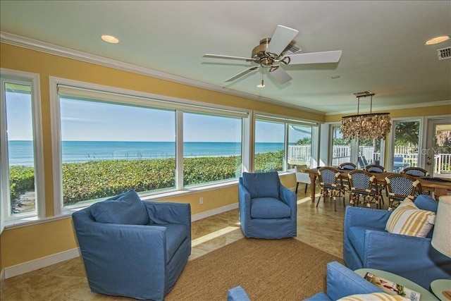 sunroom / solarium with ceiling fan, a water view, and a wealth of natural light