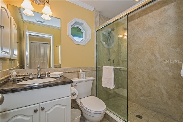 bathroom with toilet, an enclosed shower, vanity, and crown molding