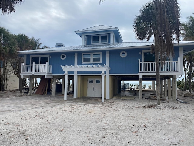 raised beach house featuring a carport