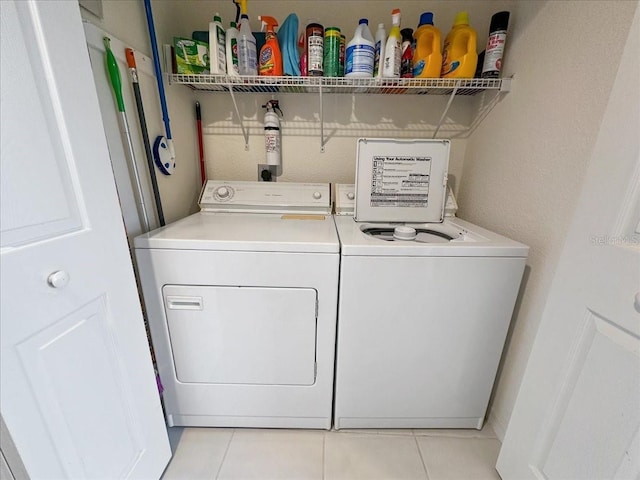 washroom with washer and dryer and light tile patterned floors