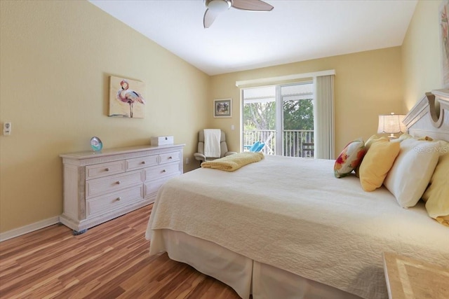 bedroom with ceiling fan, hardwood / wood-style flooring, and access to outside