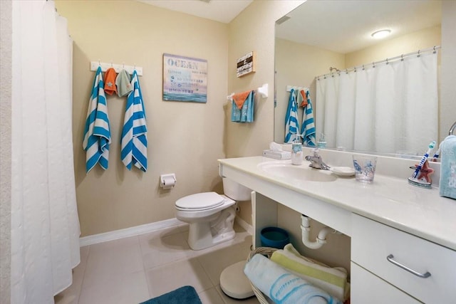 bathroom with toilet, tile patterned flooring, and sink