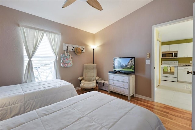 bedroom with ceiling fan and light hardwood / wood-style floors