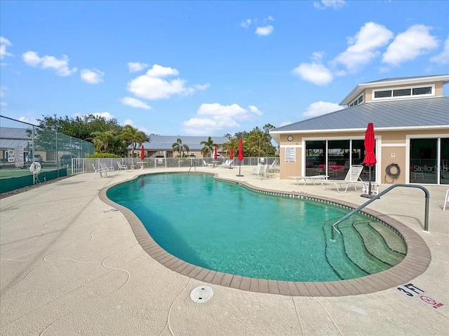 view of swimming pool with a patio