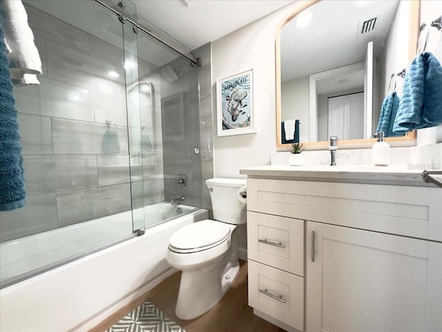 full bathroom with toilet, vanity, and combined bath / shower with glass door