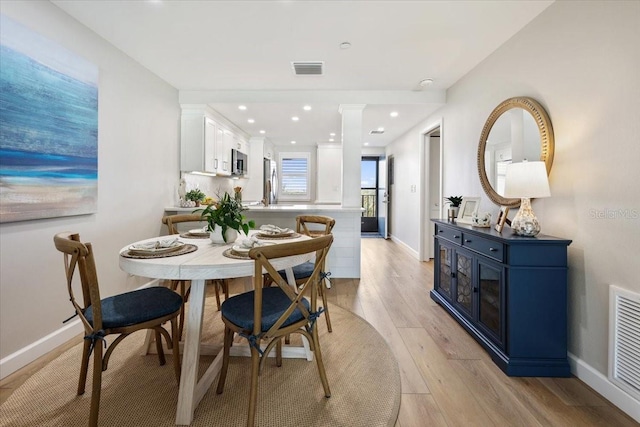 dining space with light wood-type flooring