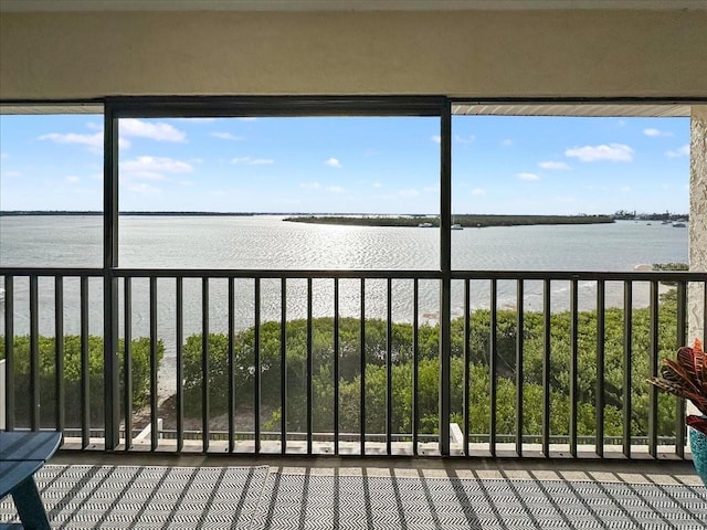 unfurnished sunroom with a healthy amount of sunlight and a water view