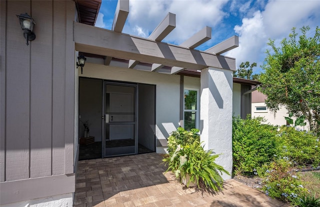 doorway to property with a patio area