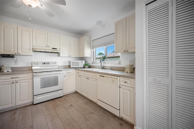 kitchen with white appliances, ceiling fan, and sink