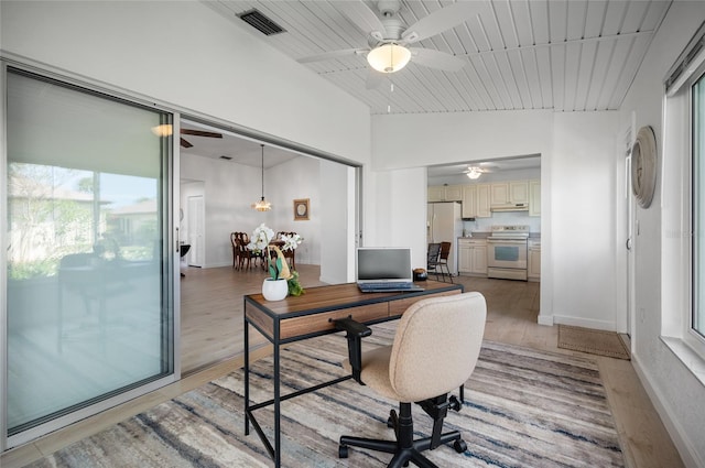 home office with light wood-type flooring, vaulted ceiling, and wooden ceiling