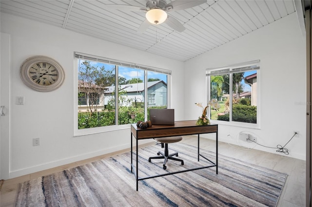 home office with ceiling fan, light hardwood / wood-style floors, and lofted ceiling