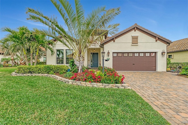 mediterranean / spanish-style house with a garage and a front lawn