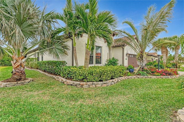 view of property exterior featuring a garage and a lawn