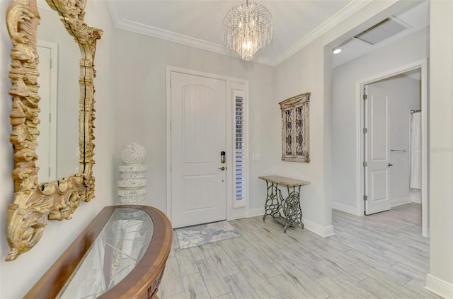 foyer featuring ornamental molding, a chandelier, and light wood-type flooring