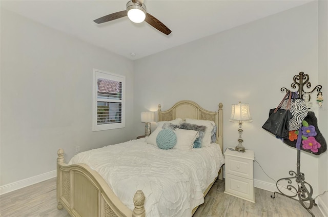 bedroom with ceiling fan and light hardwood / wood-style floors