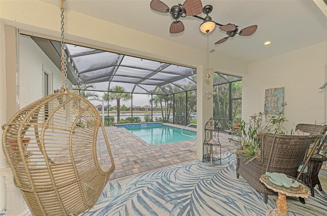 view of swimming pool featuring a lanai and a patio