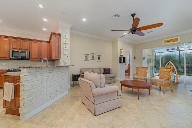 living room featuring ceiling fan and crown molding