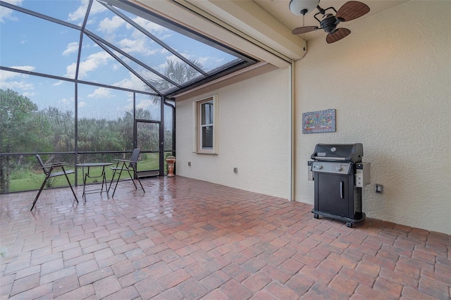 view of patio with ceiling fan, a lanai, and grilling area