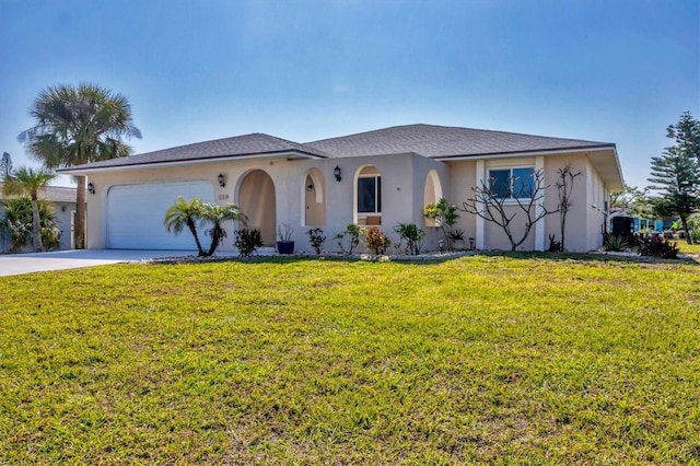 view of front of property featuring a garage and a front yard