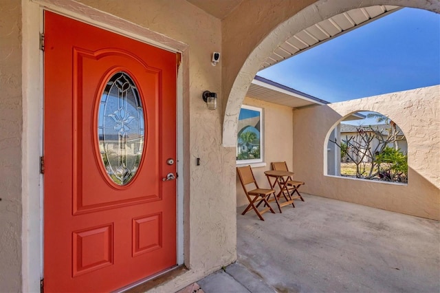 view of exterior entry featuring a porch