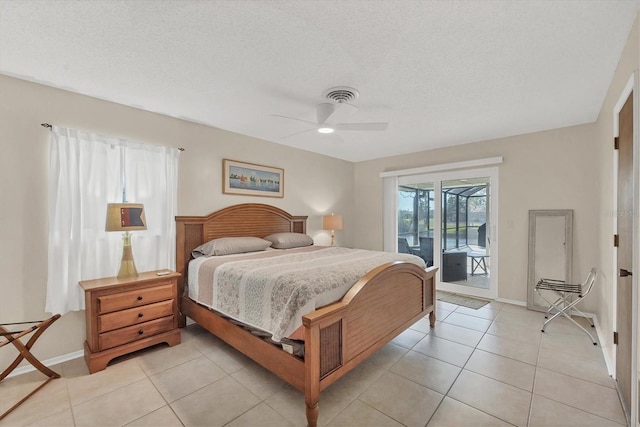 bedroom with access to exterior, ceiling fan, light tile patterned floors, and a textured ceiling