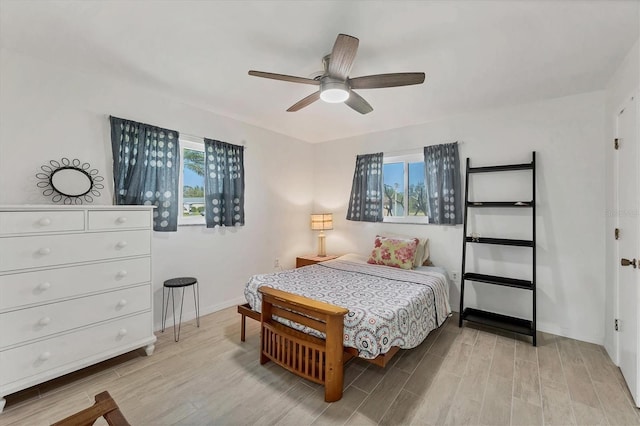 bedroom featuring multiple windows and ceiling fan