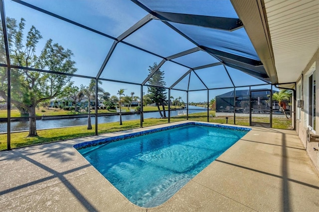 view of swimming pool featuring a yard, a patio, a water view, and a lanai