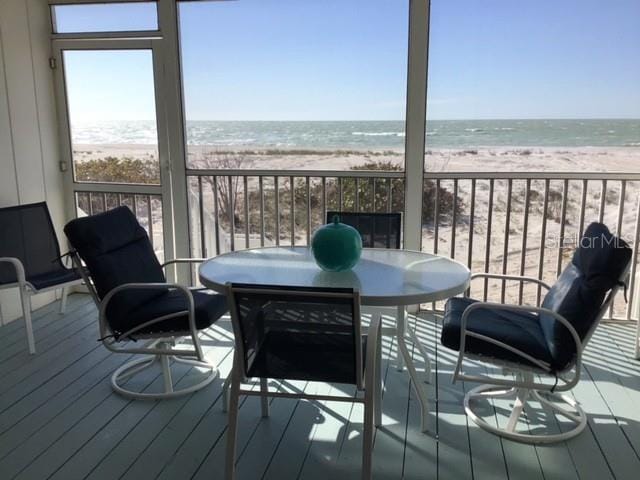 exterior space with a water view and a view of the beach