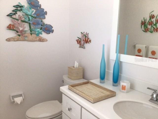 bathroom featuring vanity and toilet