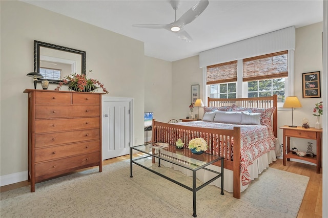 bedroom with light hardwood / wood-style floors and ceiling fan