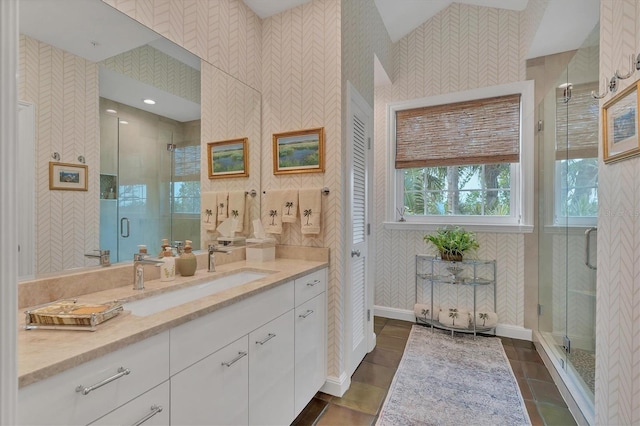 bathroom featuring a shower with door, tile patterned floors, and vanity