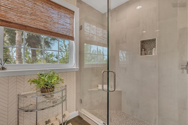 bathroom featuring a shower with door