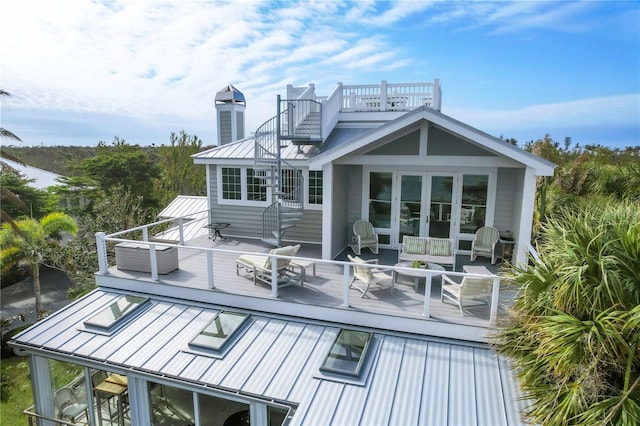 back of house featuring french doors and an outdoor hangout area