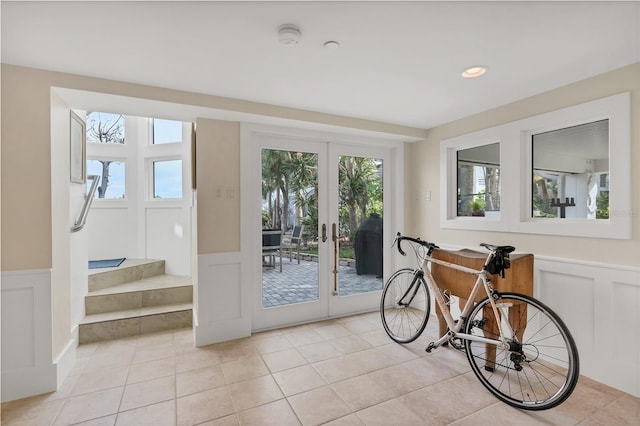 doorway to outside with light tile patterned flooring and french doors