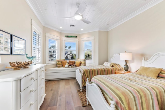 bedroom with ornamental molding, ceiling fan, wood ceiling, and light wood-type flooring