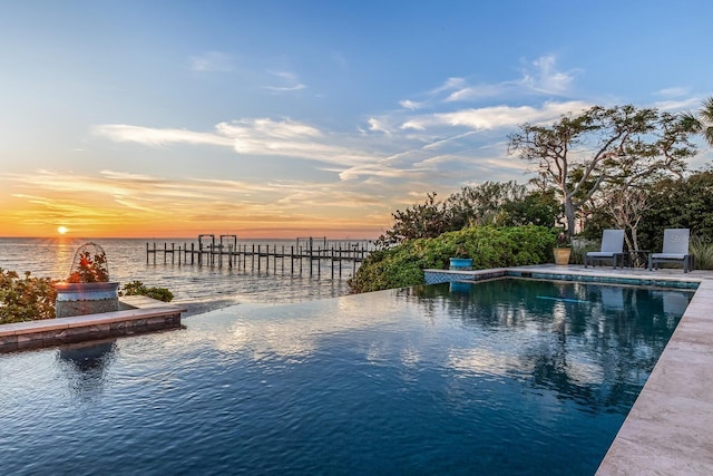 pool at dusk with a water view