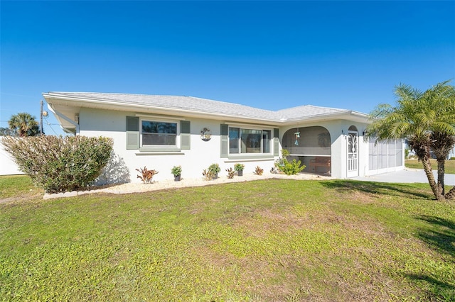 single story home featuring a sunroom and a front lawn