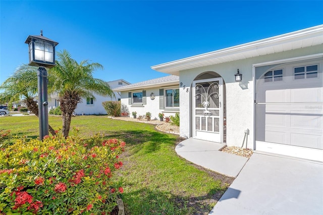 entrance to property with a lawn and a garage