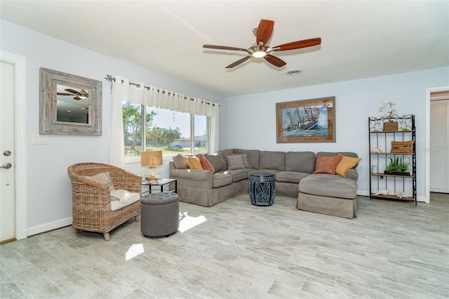 living room with light wood-type flooring and ceiling fan