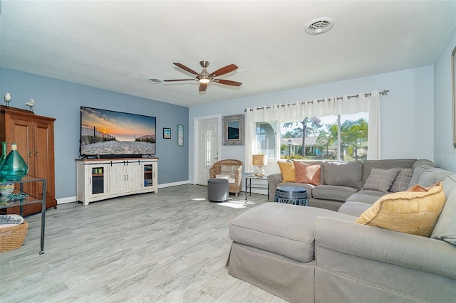 living room featuring light wood-type flooring and ceiling fan