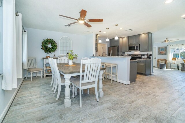 dining space with sink and ceiling fan