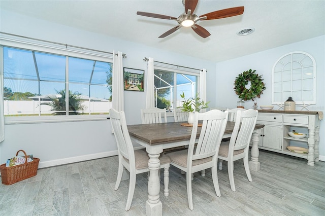 dining room with ceiling fan and light wood-type flooring