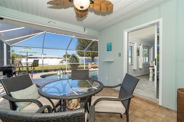 interior space featuring ceiling fan and glass enclosure