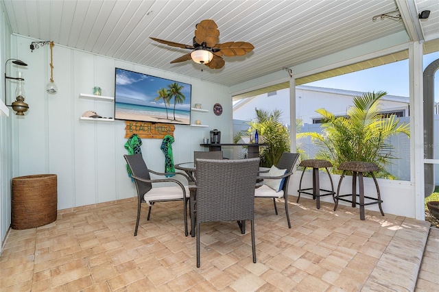 sunroom / solarium featuring wood ceiling, ceiling fan, and a wealth of natural light