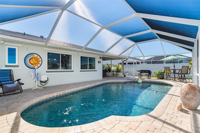 view of swimming pool with a patio area and glass enclosure