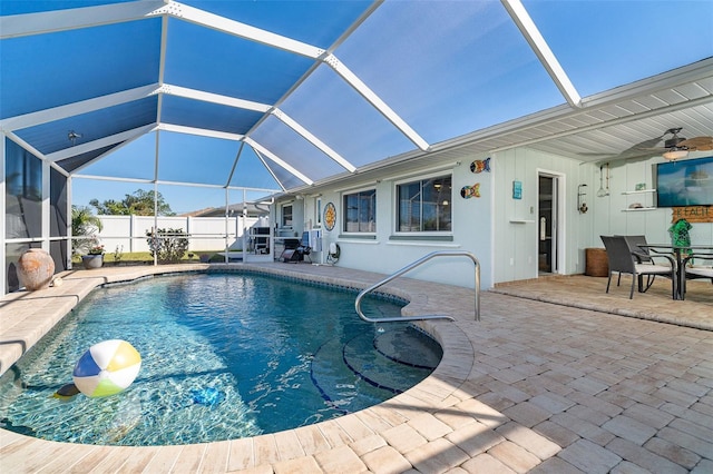 view of pool featuring ceiling fan, a patio, and glass enclosure