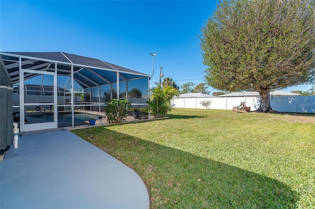 view of yard with a lanai, a patio area, and a fenced in pool