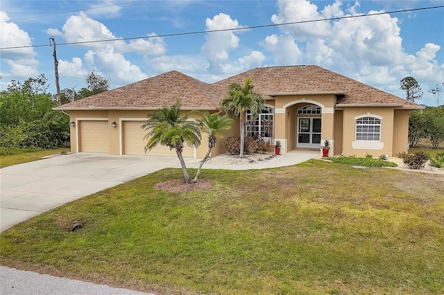 mediterranean / spanish-style home with a front lawn and a garage