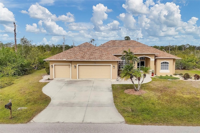 mediterranean / spanish-style home featuring a front lawn and a garage